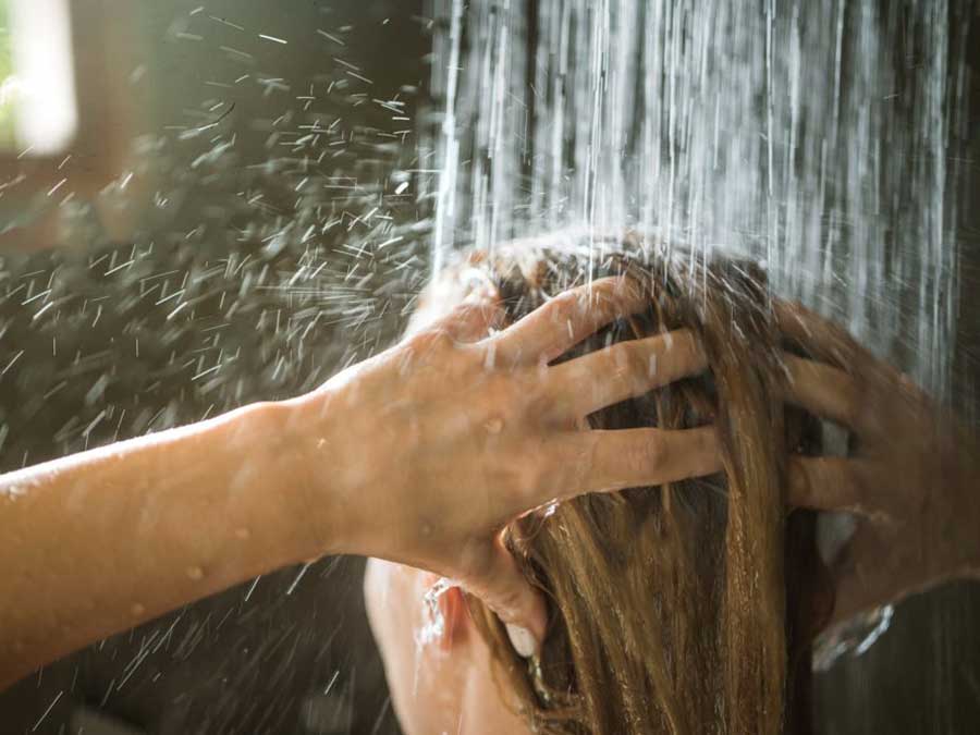 A woman taking a shower after rhinoplasty